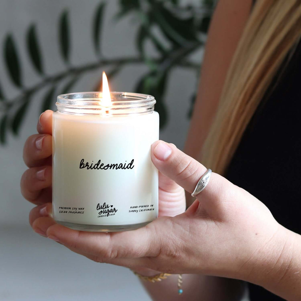 Bridesmaid candle gift held by a person, perfect for bridal party proposals and thank you gifts.