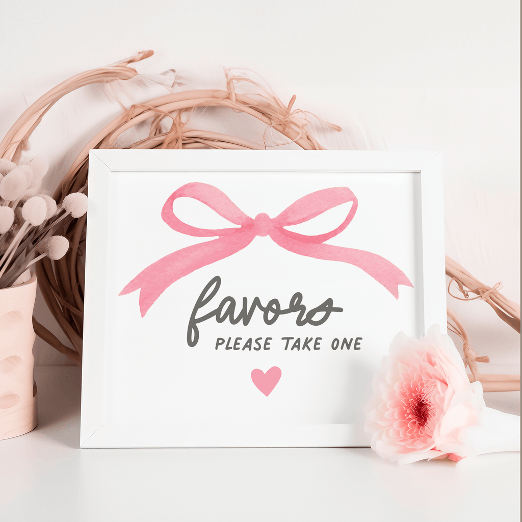 Baby shower favor sign with pink bow, inviting guests to take a personalized candle or gift.